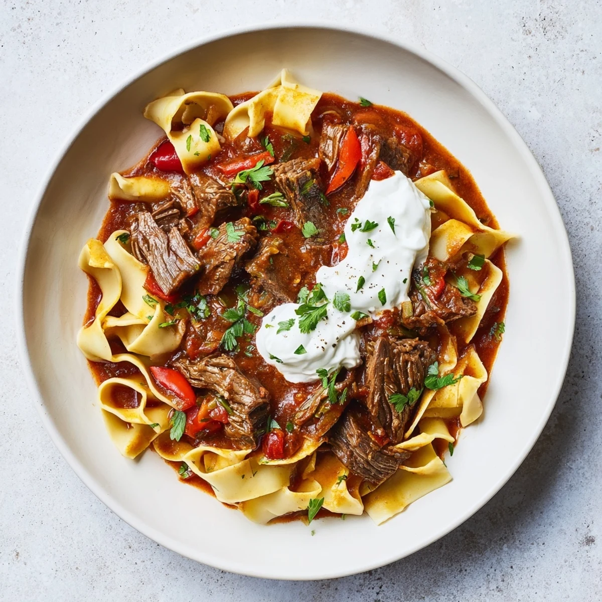 Fork-tender beef in rich paprika sauce: a visual of this classic Hungarian Goulash.