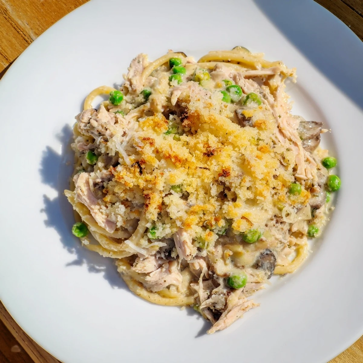 A close-up of creamy Turkey Tetrazzini, showing tender chicken, pasta, and melted cheese, perfect for dinner.
