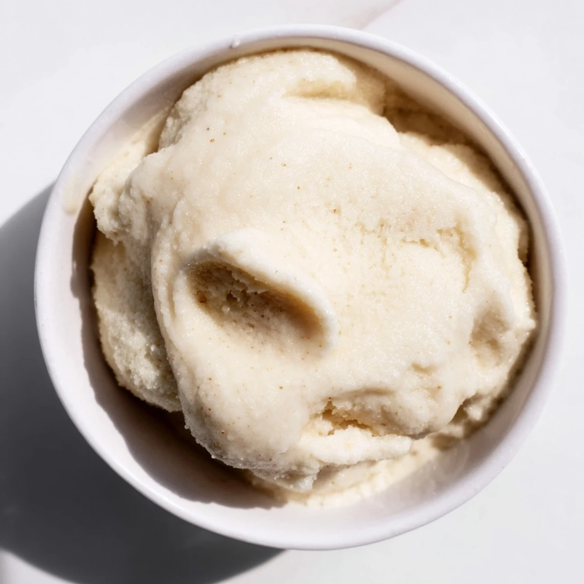 A close-up of delicious 2-Ingredient Banana Ice Cream, ready to be scooped and devoured.