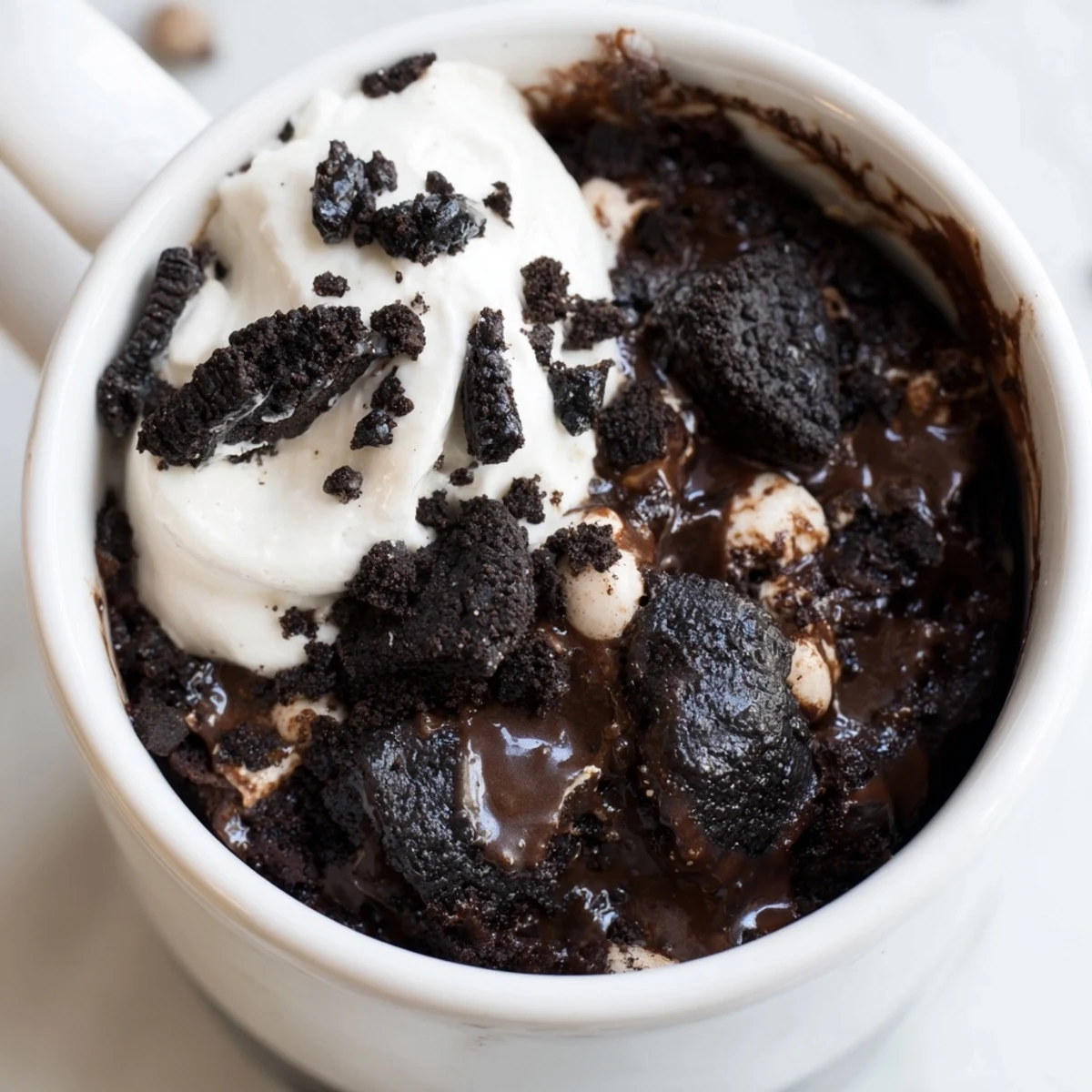 Fudgy Oreo mug cake, warm and bubbly with optional chocolate chips, ready in minutes.
