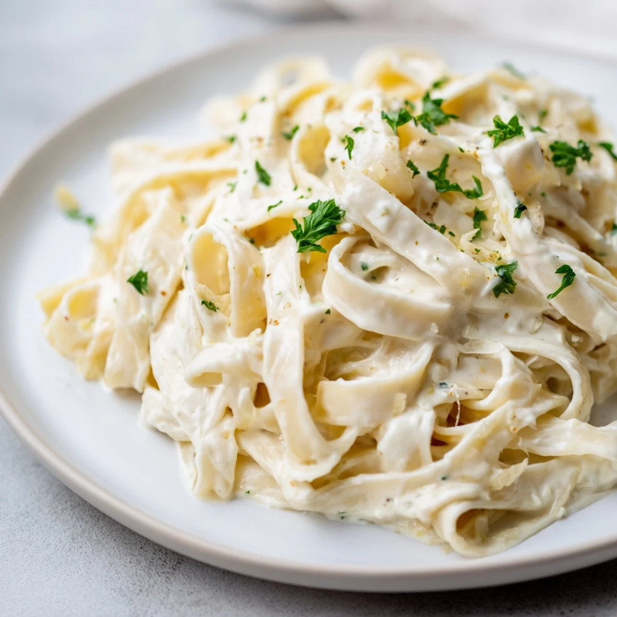 A close-up of golden Cottage Cheese Alfredo Sauce; smooth and ready to coat your pasta.