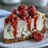 A cool slice of Indulgent White Chocolate Raspberry Cheesecake Bliss served on a white plate with fresh raspberries.