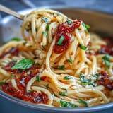 Creamy tomato basil pasta, a delicious one-pot meal topped with fresh basil.