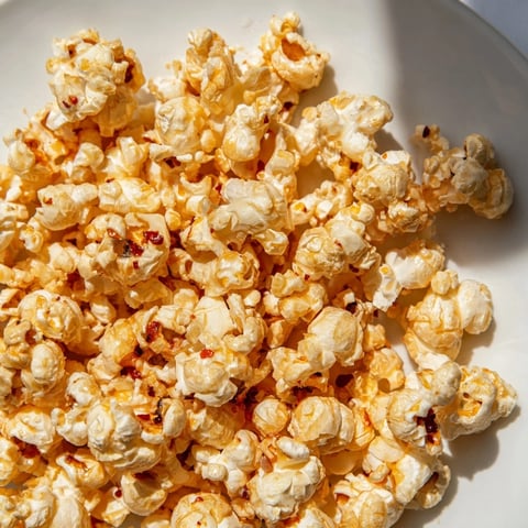 Golden, glistening Hot Honey Butter Popcorn, with a sweet, spicy aroma and perfectly coated kernels.