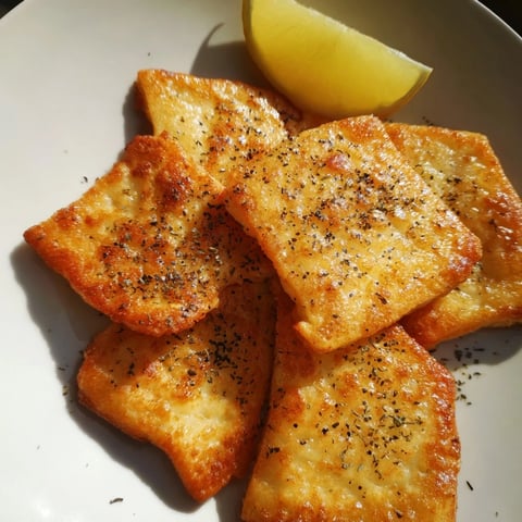 Golden, crispy Greek Saganaki cheese, pan-fried and ready to squeeze with lemon, a savory appetizer.