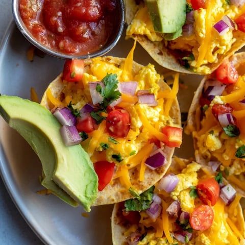 Golden-brown Sheet Pan Breakfast Tacos filled with fluffy scrambled eggs, melted cheddar, and fresh avocado slices.