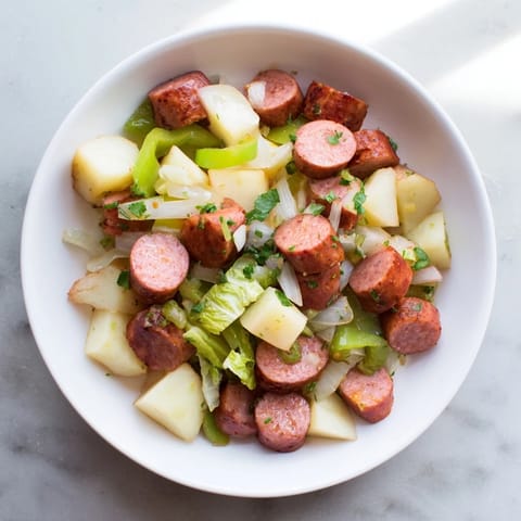 Smoky kielbasa and tender cabbage mingling with potatoes in this flavorful skillet hash.