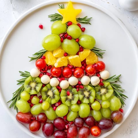 A delightful view of this Christmas Tree Triangle Board, featuring vibrant olives and grape "ornaments".