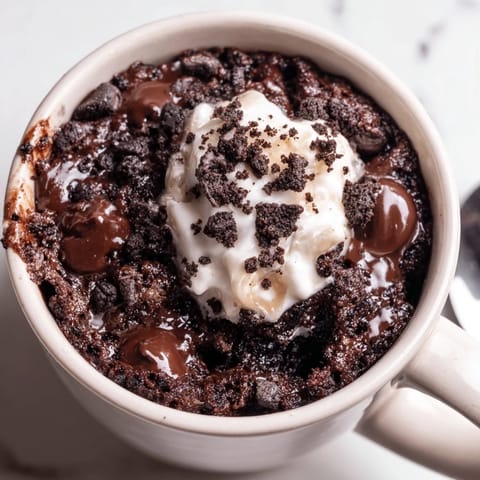 This single-serve Oreo mug cake features fluffy, microwave-baked chocolate goodness, perfect for dessert.