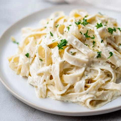 A close-up of golden Cottage Cheese Alfredo Sauce; smooth and ready to coat your pasta.