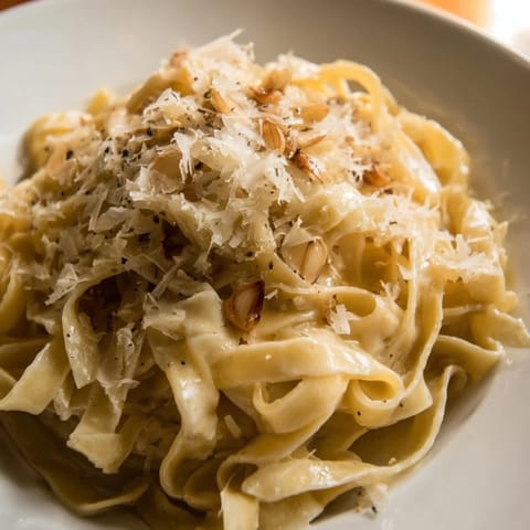 A comforting bowl of Roasted Garlic Cream Pasta with silky sauce and freshly grated Parmesan, ready to enjoy.