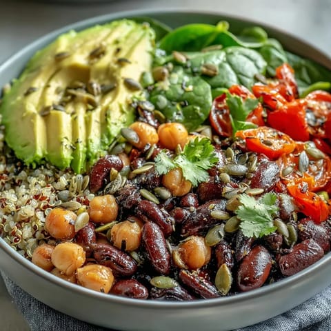 A hearty Three-Bean Power Bowl with quinoa, mixed beans, and colorful vegetables, ready to serve as a protein-packed dinner.