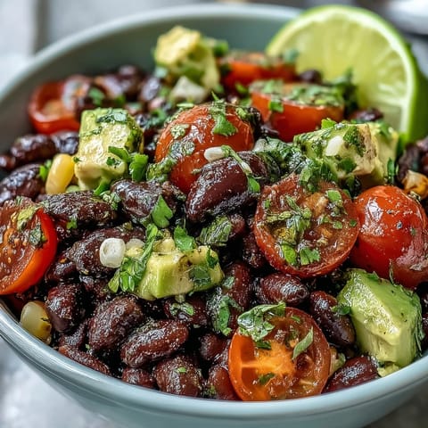 Colorful Black Bean and Veggie Bowl topped with cilantro and pumpkin seeds, perfect for a healthy lunch.