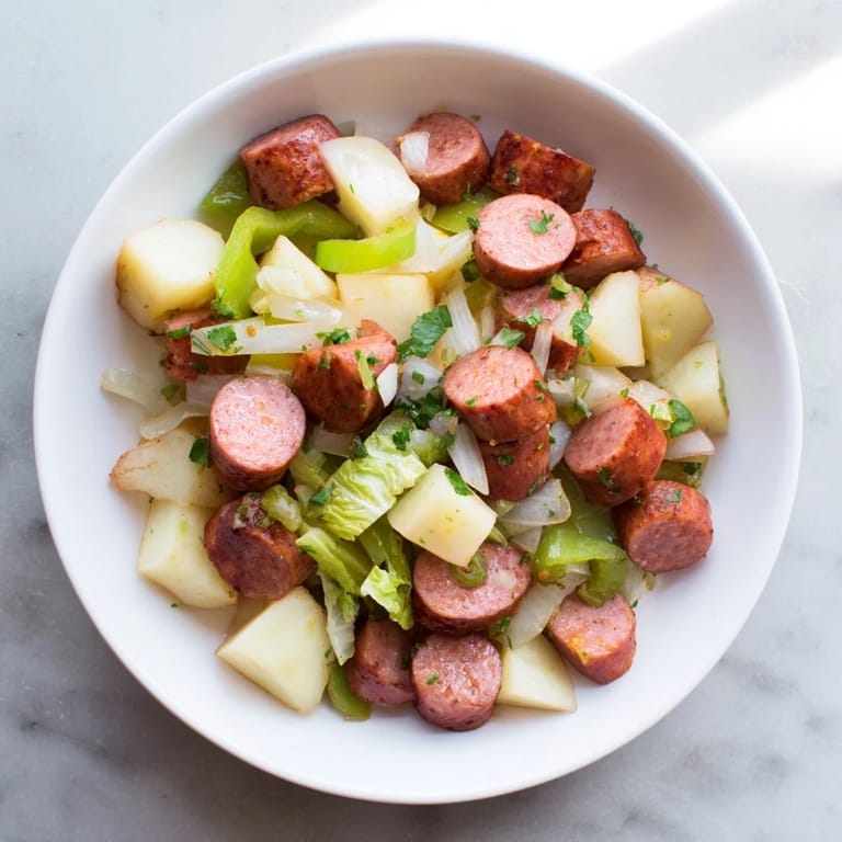 Smoky kielbasa and tender cabbage mingling with potatoes in this flavorful skillet hash.