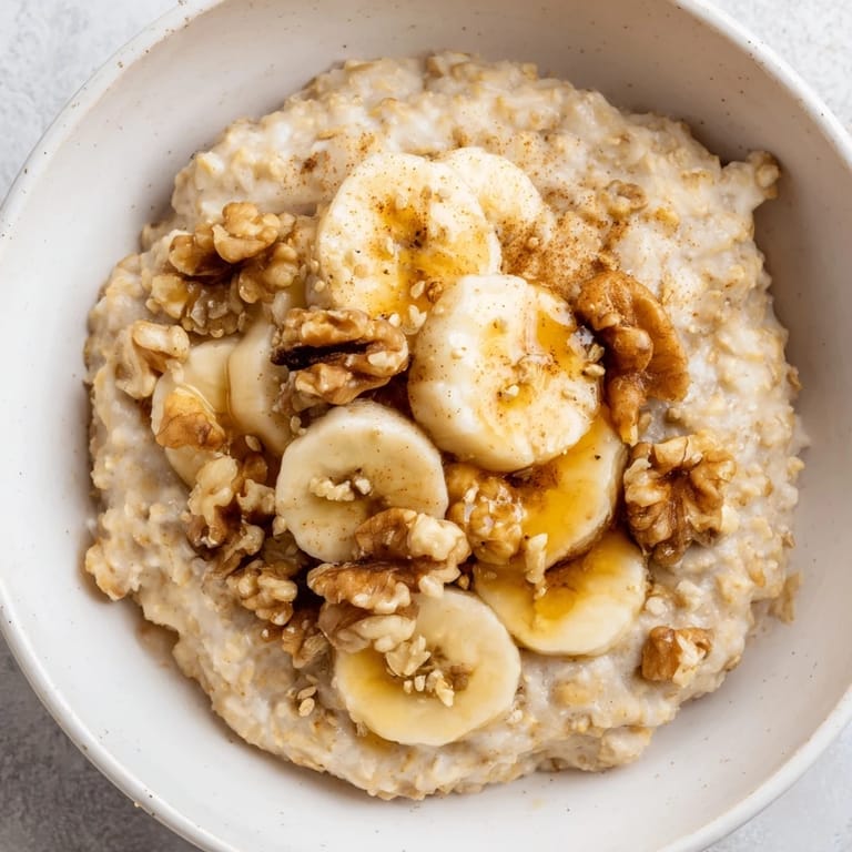 Warm and creamy Microwave Banana Oats, beautifully topped with fresh banana and nuts for flavor.