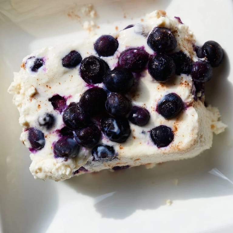 Fresh, high-protein Blueberry Cottage Cheese Bake with a hint of lemon, perfect for breakfast prep.