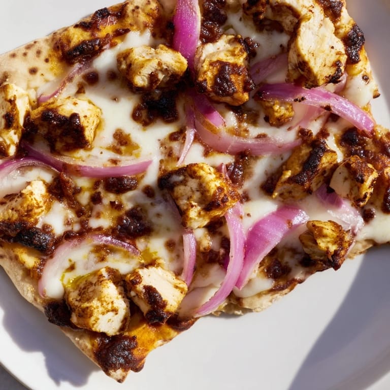 Perfectly melted mozzarella blankets tender chicken on a crispy flatbread for a quick weeknight dinner.