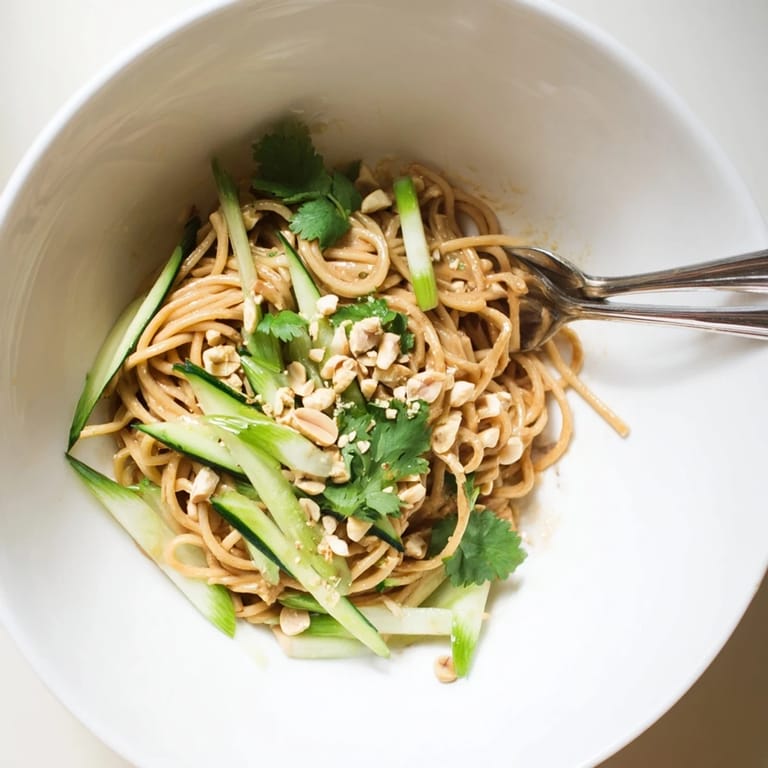 Close-up of Spicy Sesame Noodle Salad with noodles tossed in bold sesame dressing and peanuts.