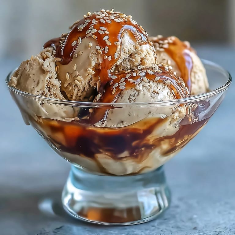 Rich Hojicha Affogato with vanilla ice cream and toasted sesame seeds in a glass.